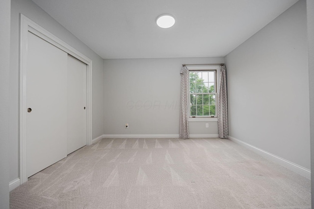 382 Beecher Rd, Columbus, OH 43230 - unfurnished bedroom featuring light carpet, baseboards, and a closet
