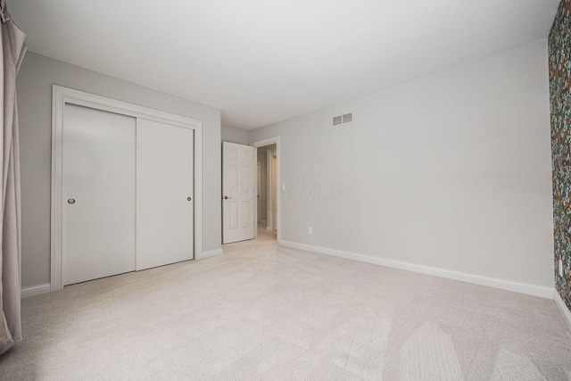 382 Beecher Rd, Columbus, OH 43230 - unfurnished bedroom featuring light carpet, baseboards, and a closet