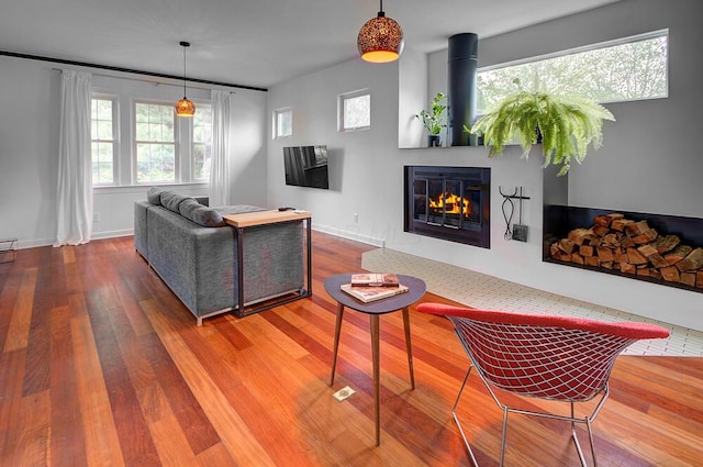 668 Enfield Rd, Columbus, OH 43209 - living area featuring wood finished floors, a glass covered fireplace, and baseboards