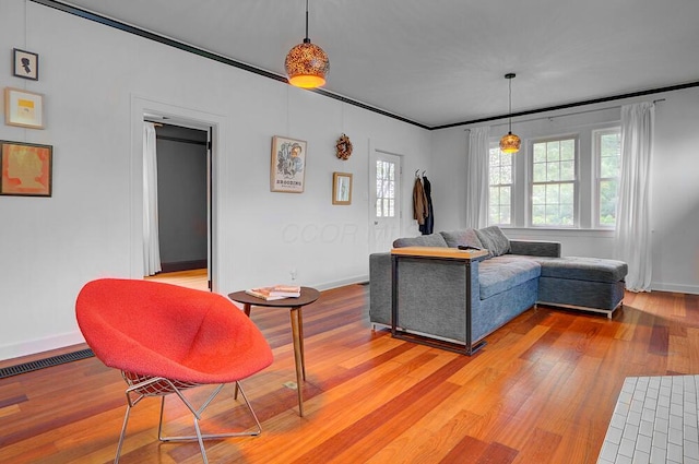 668 Enfield Rd, Columbus, OH 43209 - living room with baseboards, light wood finished floors, and crown molding