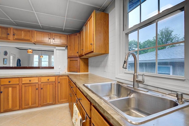 668 Enfield Rd, Columbus, OH 43209 - kitchen featuring a sink, brown cabinetry, healthy amount of natural light, and light tile patterned floors