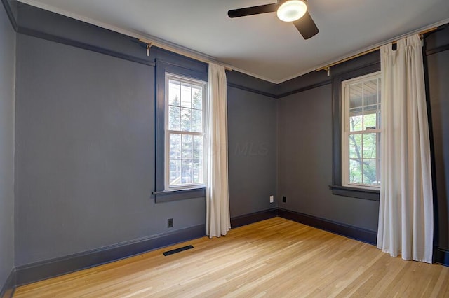 668 Enfield Rd, Columbus, OH 43209 - unfurnished room featuring light wood-style flooring, ceiling fan, plenty of natural light, ornamental molding, and baseboards