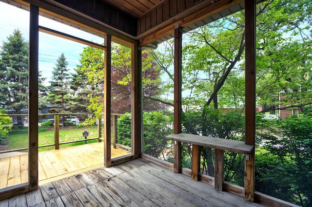 668 Enfield Rd, Columbus, OH 43209 - unfurnished sunroom featuring a deck, hardwood / wood-style flooring, and view of scattered trees