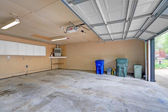 668 Enfield Rd, Columbus, OH 43209 - garage with a garage door opener and water heater