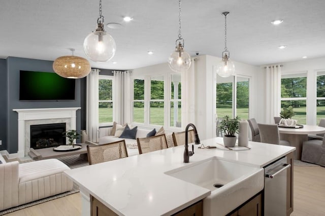 kitchen featuring a sink, open floor plan, and light countertops