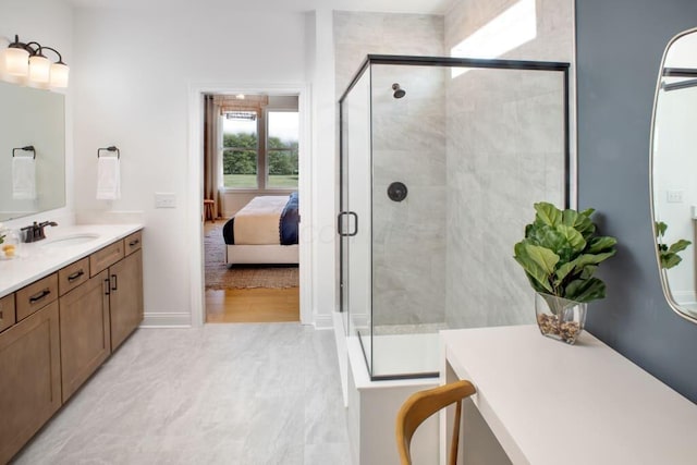 bathroom with a shower stall, baseboards, connected bathroom, and vanity