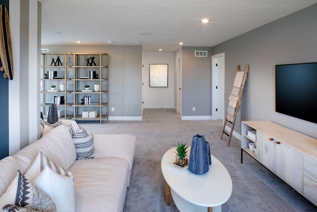 living area with baseboards, recessed lighting, visible vents, and carpet floors