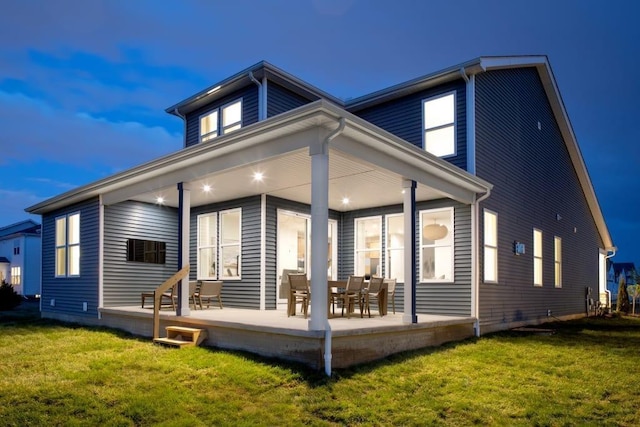back of house with a lawn