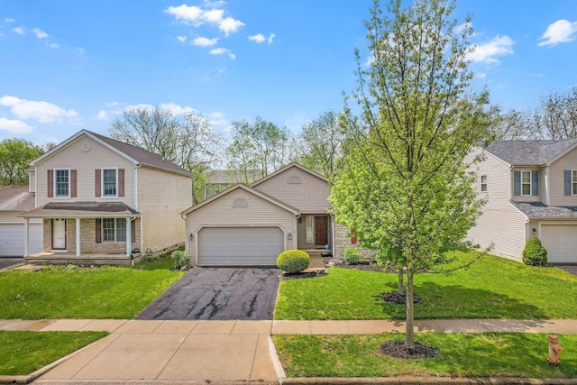 2099 Winding Hollow Dr, Grove City, OH 43123 - view of front of property featuring a front yard, aphalt driveway, and an attached garage