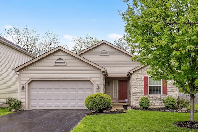 2099 Winding Hollow Dr, Grove City, OH 43123 - ranch-style home with a front yard, a garage, stone siding, and driveway