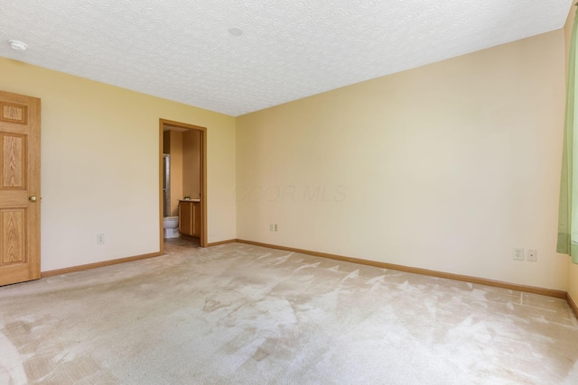 2099 Winding Hollow Dr, Grove City, OH 43123 - empty room featuring baseboards, a textured ceiling, and light colored carpet