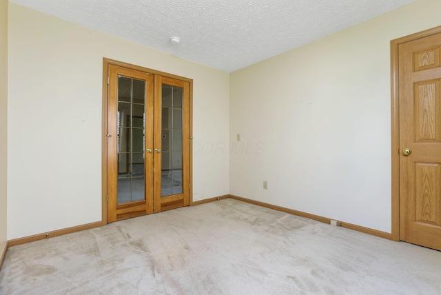 2099 Winding Hollow Dr, Grove City, OH 43123 - carpeted spare room featuring baseboards, french doors, and a textured ceiling