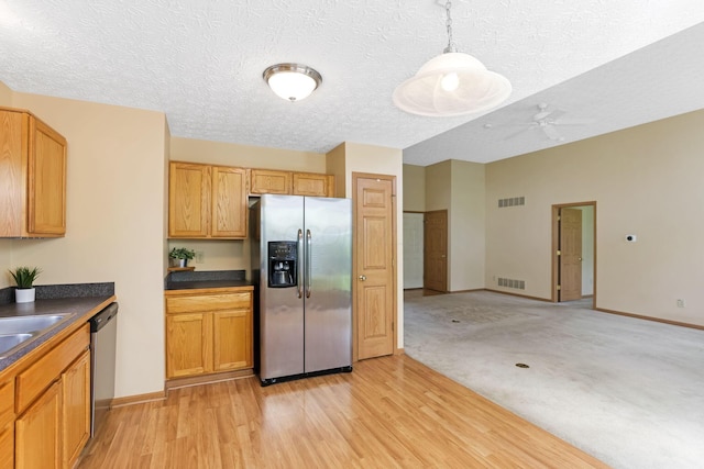 2099 Winding Hollow Dr, Grove City, OH 43123 - kitchen with dark countertops, appliances with stainless steel finishes, visible vents, and a textured ceiling