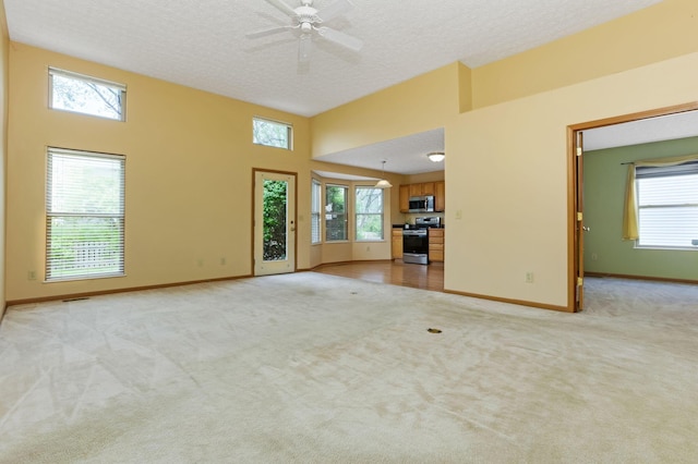 2099 Winding Hollow Dr, Grove City, OH 43123 - unfurnished living room featuring plenty of natural light, light carpet, and baseboards