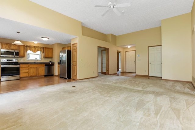2099 Winding Hollow Dr, Grove City, OH 43123 - unfurnished living room with a ceiling fan, light carpet, a textured ceiling, and baseboards