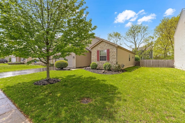 2099 Winding Hollow Dr, Grove City, OH 43123 - view of front of home with stone siding, a front yard, and fence
