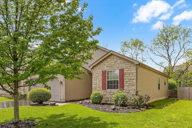 2099 Winding Hollow Dr, Grove City, OH 43123 - view of side of property with a yard, stone siding, a garage, and fence