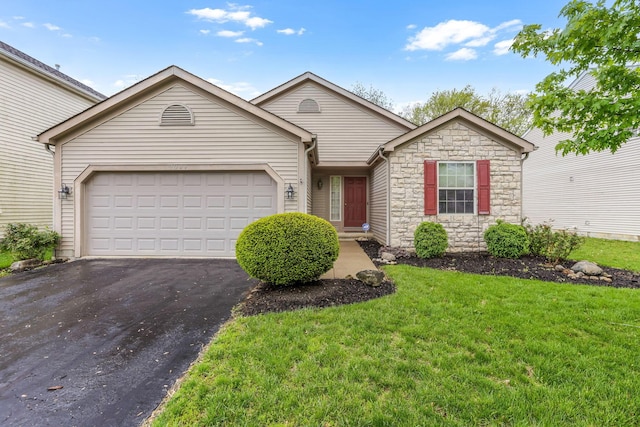 2099 Winding Hollow Dr, Grove City, OH 43123 - single story home featuring an attached garage, driveway, a front yard, and stone siding