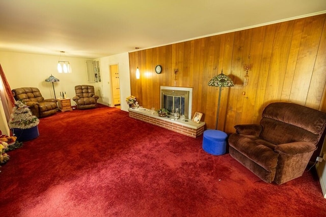 living area featuring a fireplace, wood walls, and carpet floors