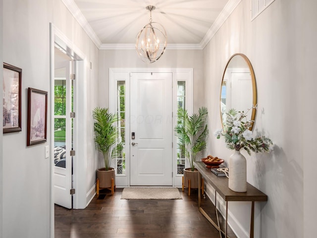 foyer featuring a chandelier, crown molding, and dark wood-style floors
