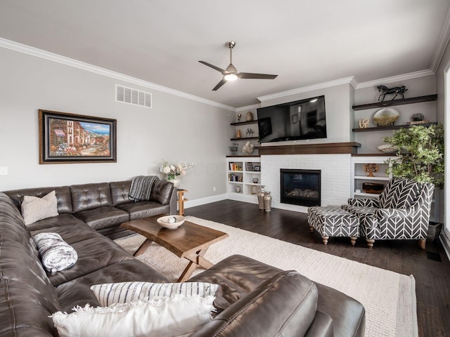 living room with ornamental molding, a ceiling fan, visible vents, and dark wood-type flooring