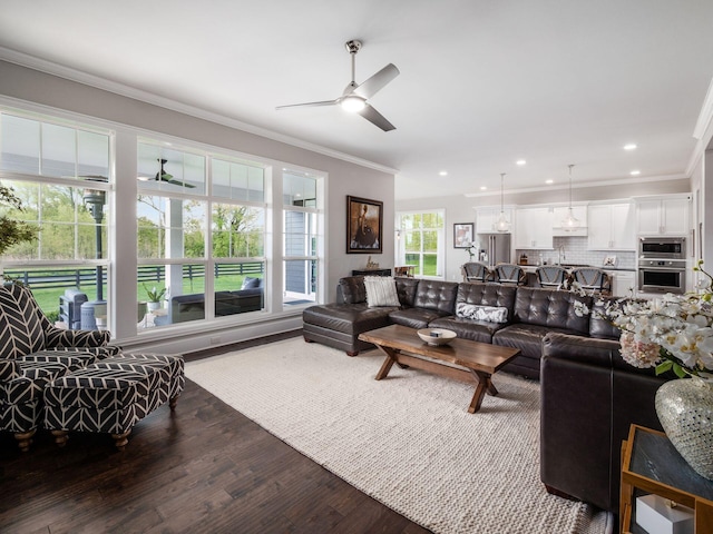 living area with ceiling fan, wood finished floors, ornamental molding, and recessed lighting
