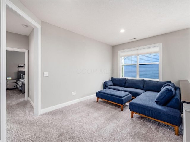 carpeted living area with baseboards, visible vents, and recessed lighting