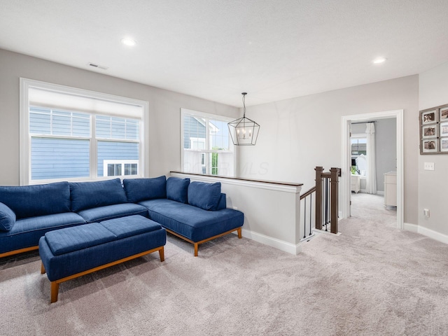 living area with an inviting chandelier, carpet floors, visible vents, baseboards, and recessed lighting