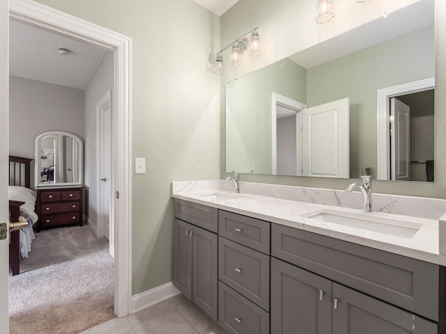 full bath with ensuite bath, tile patterned floors, double vanity, and a sink