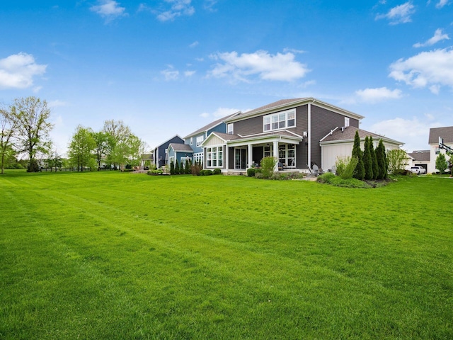 rear view of house with a yard