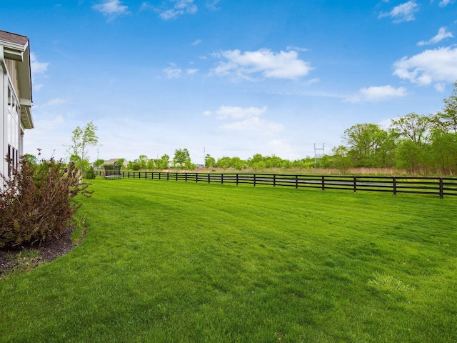 view of yard featuring a rural view and fence