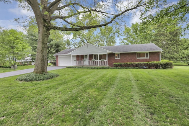 ranch-style home featuring a garage, a porch, driveway, a front lawn, and brick siding