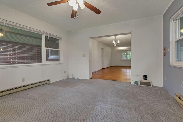 empty room featuring carpet flooring, ornamental molding, a chandelier, a ceiling fan, and baseboard heating