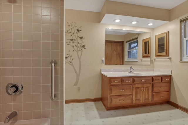 full bathroom featuring baseboards, vanity, tile patterned floors, and shower / washtub combination