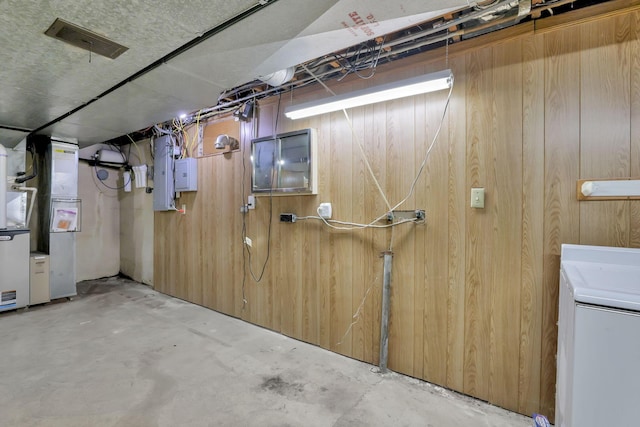 unfinished below grade area with washer / clothes dryer and wood walls