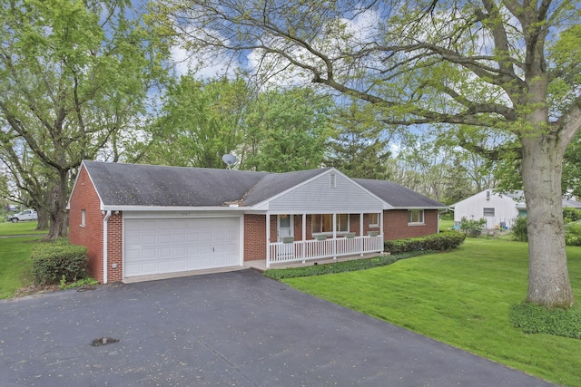 single story home with a porch, brick siding, an attached garage, asphalt driveway, and a front lawn