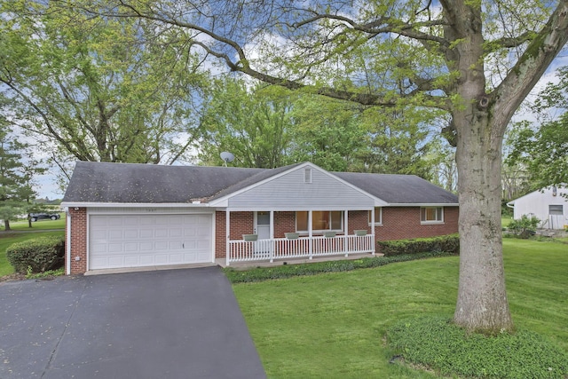 single story home with brick siding, a porch, an attached garage, a front yard, and asphalt driveway