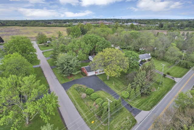 aerial view of property's location featuring a tree filled landscape