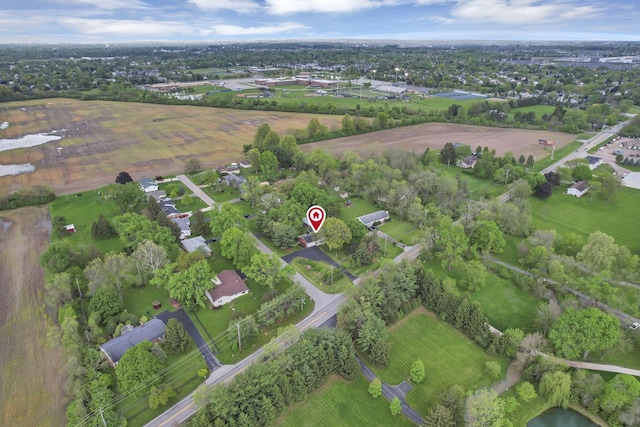 aerial view of property and surrounding area featuring a tree filled landscape