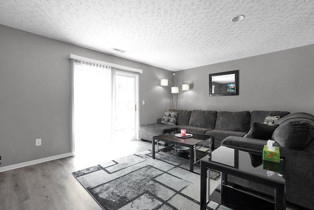 4830 Brice Pond Dr Unit 1A, Canal Winchester, OH 43110 - living room featuring wood finished floors, a textured ceiling, and baseboards