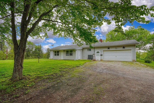 single story home featuring a chimney, dirt driveway, cooling unit, a garage, and a front lawn