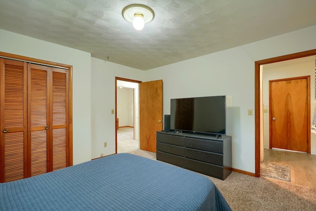 bedroom featuring baseboards, a closet, and carpet floors