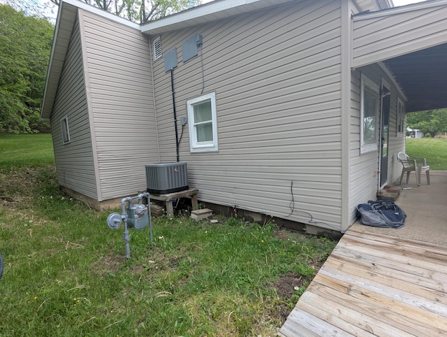 view of side of home featuring central AC