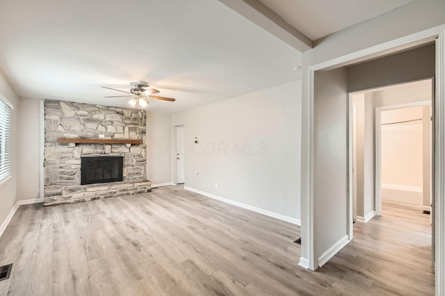 3140 Hamilton Ave, Columbus, OH 43224 - unfurnished living room featuring ceiling fan, wood finished floors, baseboards, and a stone fireplace
