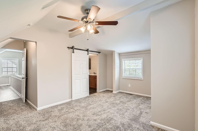 3140 Hamilton Ave, Columbus, OH 43224 - bonus room featuring vaulted ceiling, carpet, a barn door, ceiling fan, and baseboards