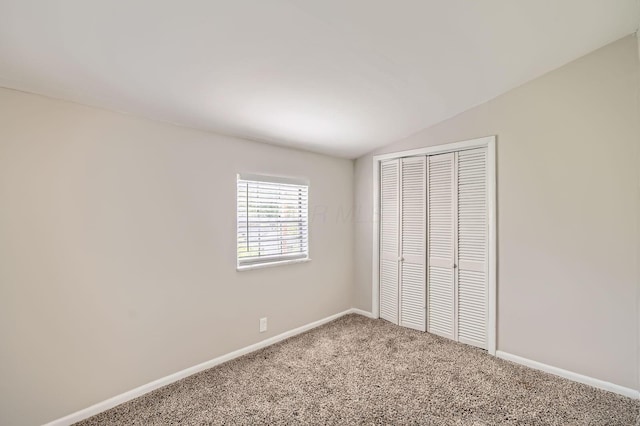 3140 Hamilton Ave, Columbus, OH 43224 - unfurnished bedroom with vaulted ceiling, carpet floors, a closet, and baseboards