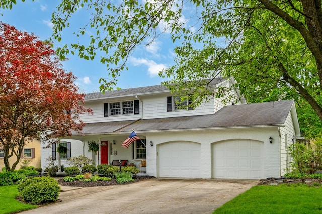 traditional-style home featuring brick siding, concrete driveway, and a shingled roof