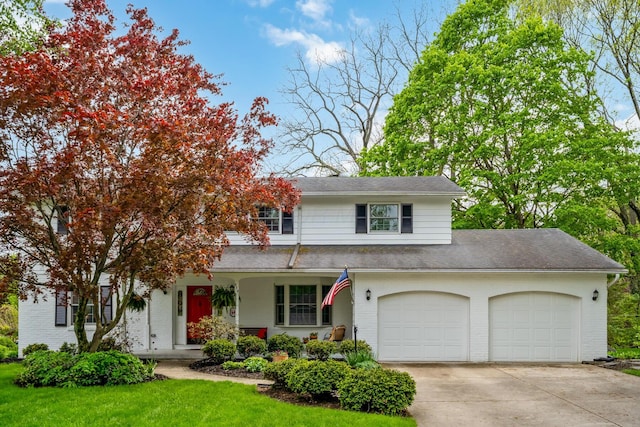 traditional-style house with brick siding, driveway, an attached garage, roof with shingles, and a front yard