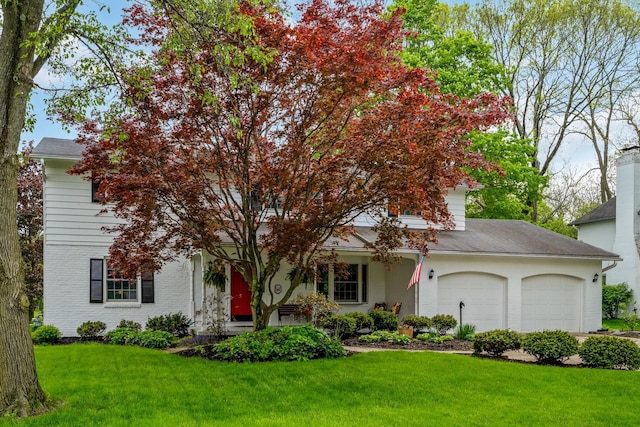 obstructed view of property with a garage, a front lawn, and brick siding