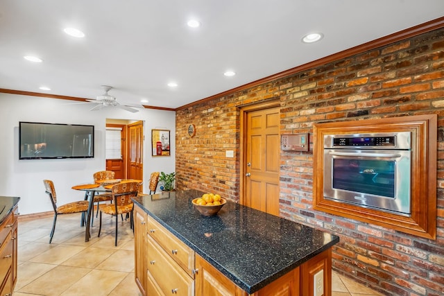 kitchen featuring stainless steel oven, crown molding, recessed lighting, light tile patterned floors, and ceiling fan